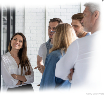 Hypothetical group of modern art collectors viewing works by the artist. (stock photo)
