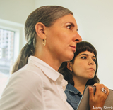 Hypothetical group of two modern art collectors learning about Gerzso collectors (stock photo)